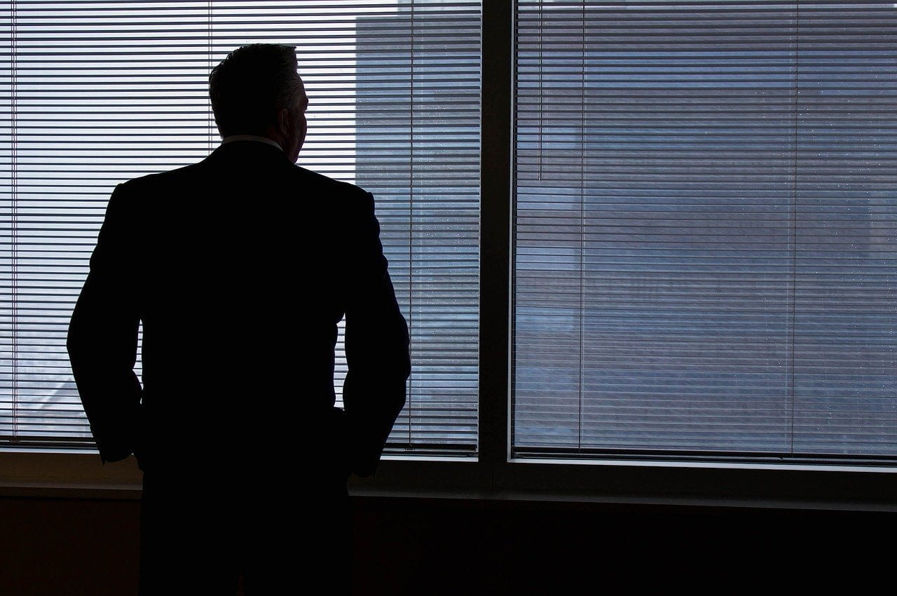 a man standing in front of a window