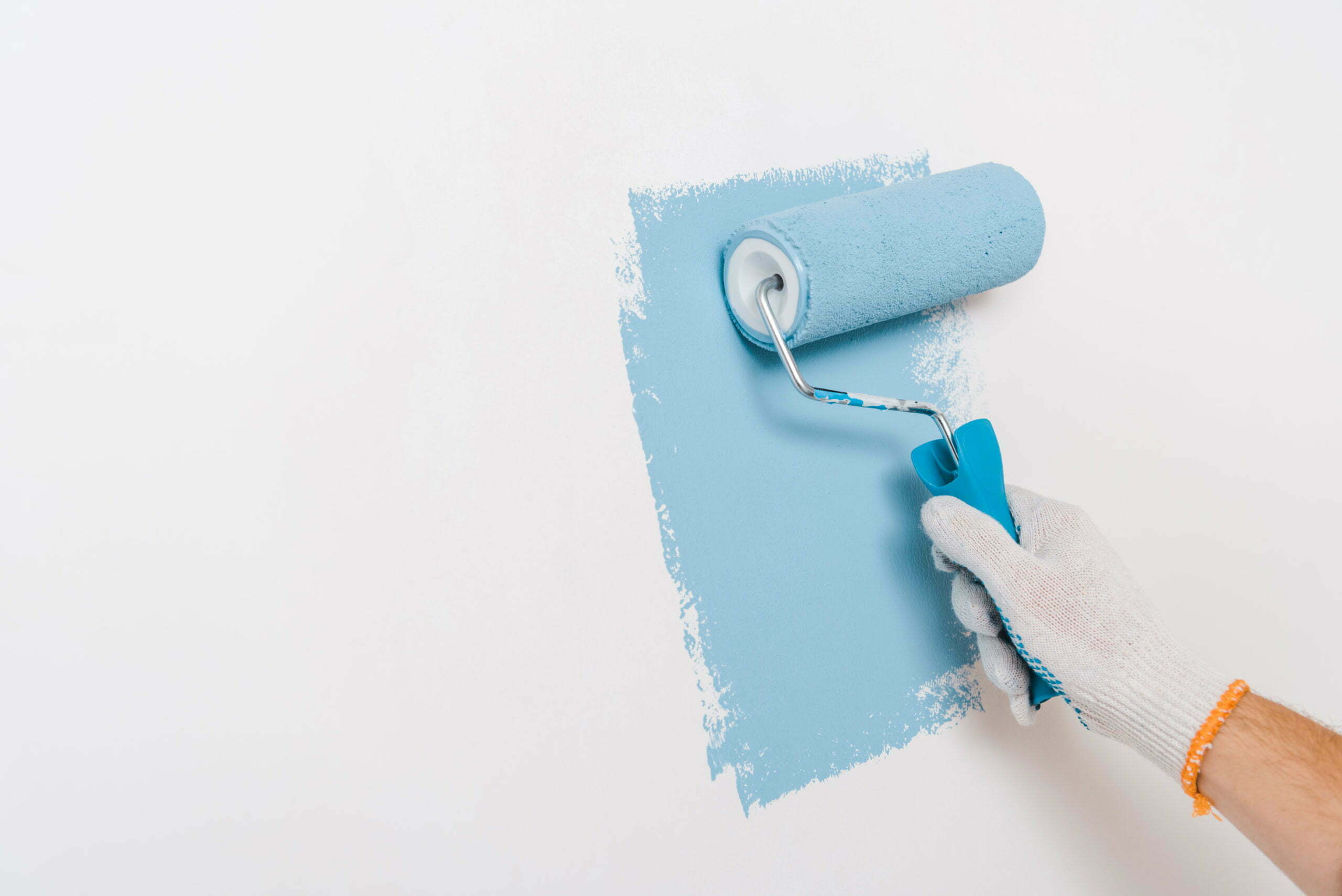 painting wall in blue color at home